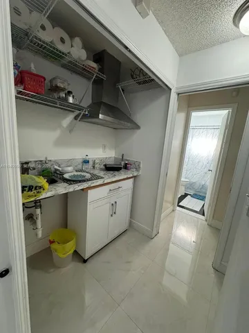 a kitchen with a sink and wooden cabinets