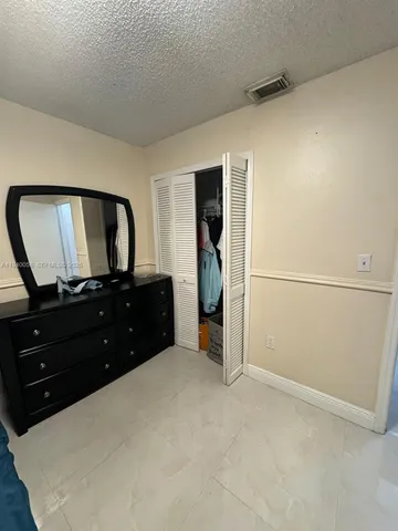 a room with a bed and a mirror on the wall