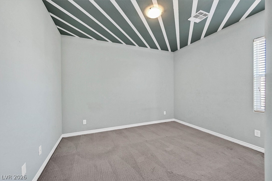 1106 Langston Ranch Avenue Henderson, NV 89002 - Photo 25 of 36 Bold ceiling stripes add a unique touch to this cozy room with plush carpet.
