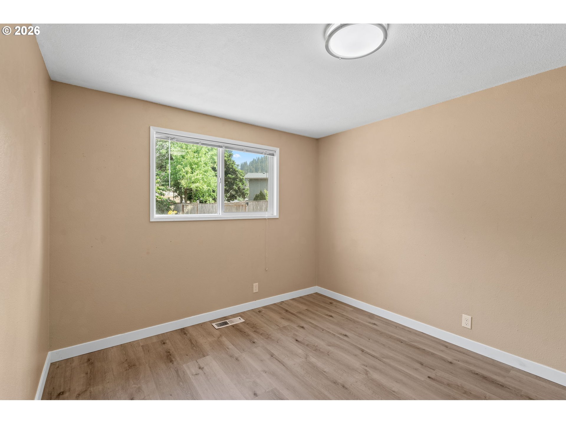 6445 B Street Springfield, OR 97478 - Photo 12 of 26 a view of an empty room with a window
