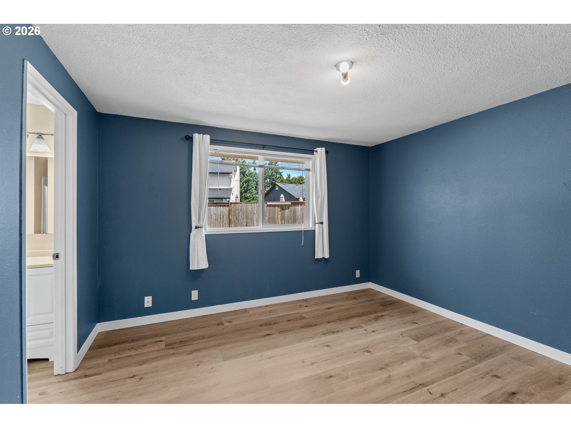 6445 B Street Springfield, OR 97478 - Photo 14 of 26 a view of an empty room with wooden floor and a window