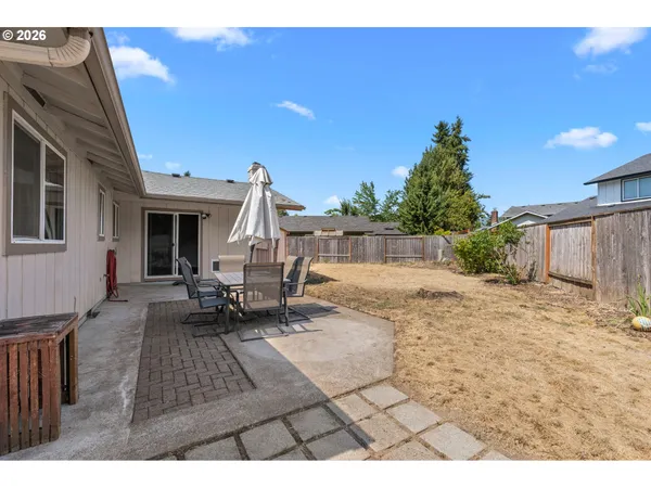 a view of a backyard with sitting area