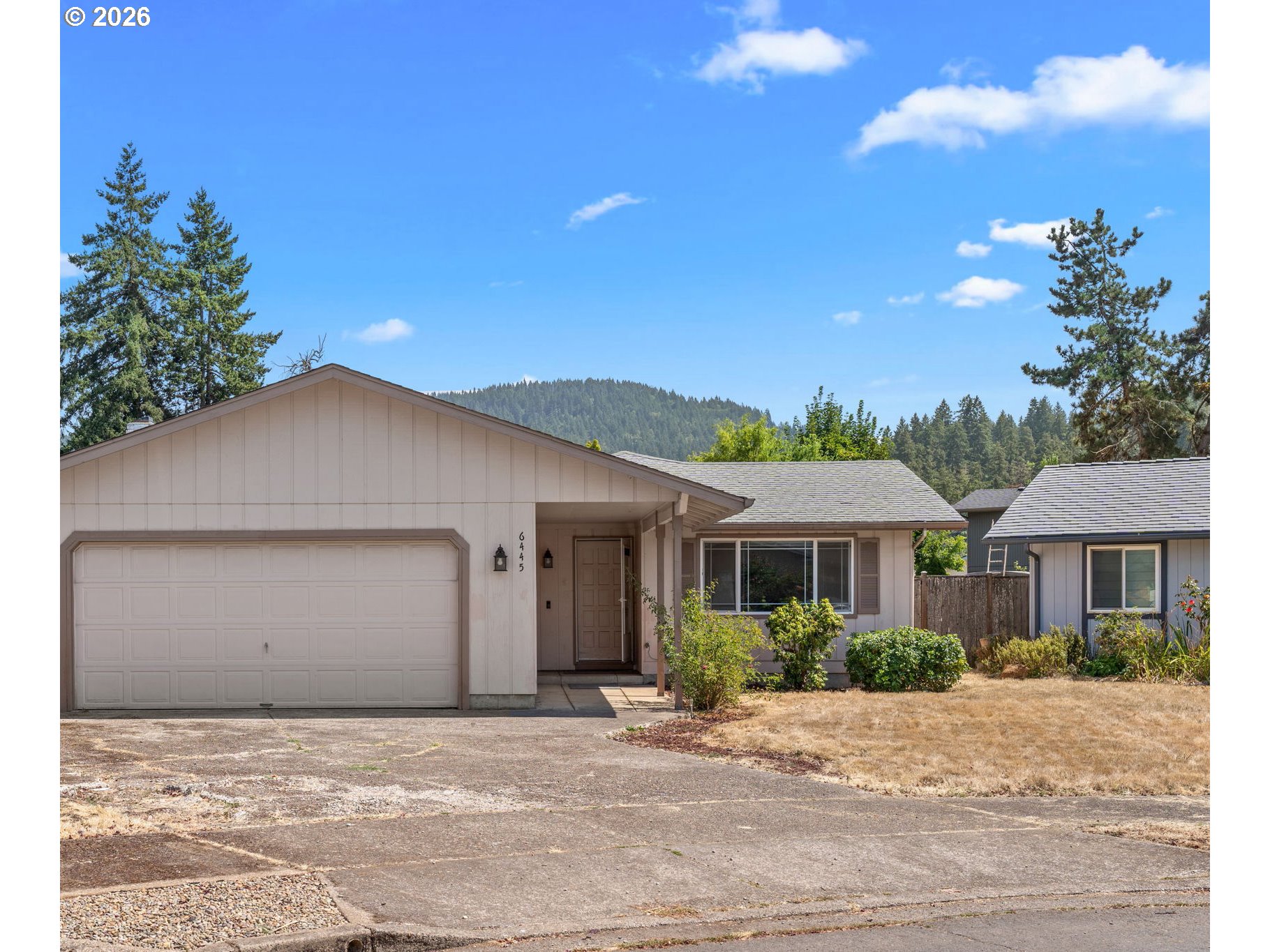 6445 B Street Springfield, OR 97478 - Photo 3 of 26 a front view of a house with a yard and garage