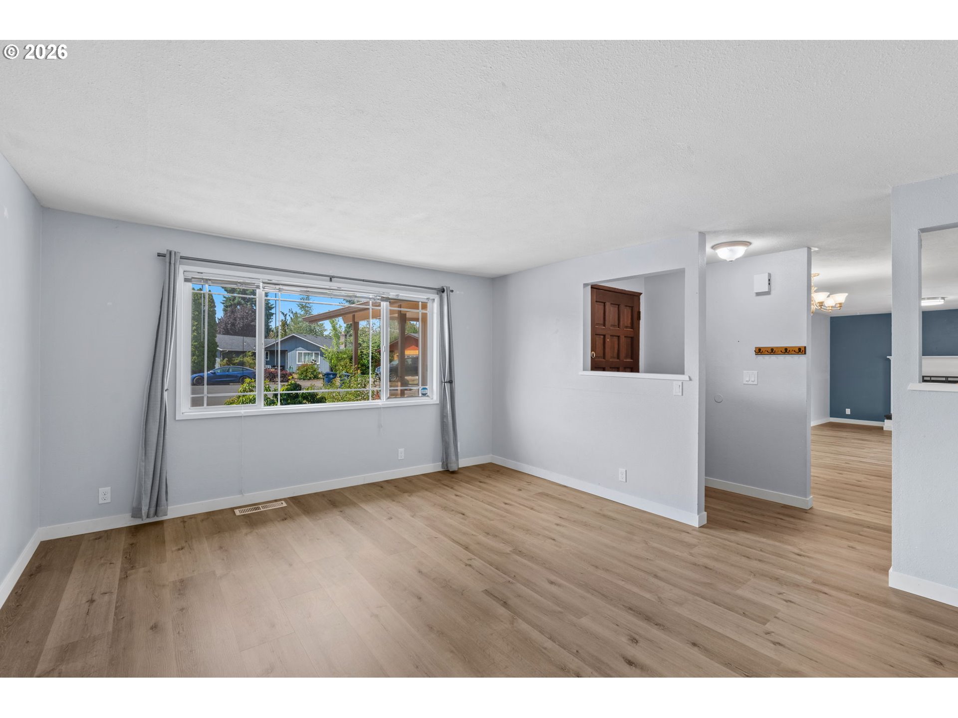 6445 B Street Springfield, OR 97478 - Photo 5 of 26 a view of an empty room with wooden floor and a window