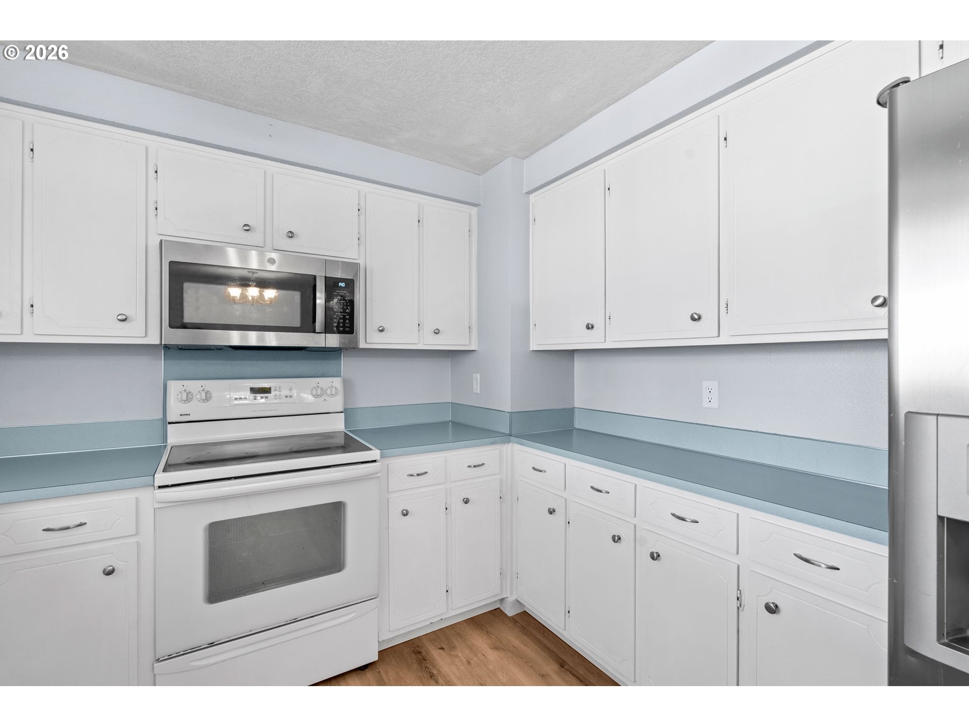 6445 B Street Springfield, OR 97478 - Photo 7 of 26 a kitchen with white cabinets stainless steel appliances and sink