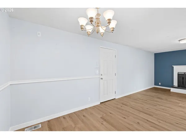 a view of a room with wooden floor
