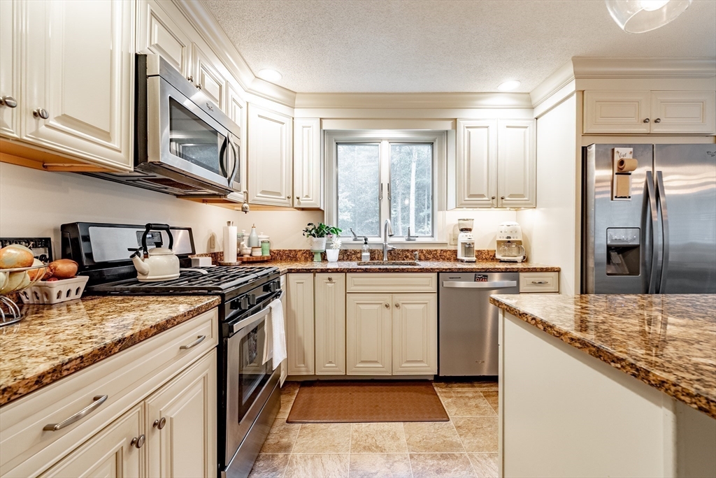 24 Rambling Drive Westfield, MA 01085 - Photo 4 of 39 a kitchen with stainless steel appliances granite countertop a stove top oven a sink and dishwasher