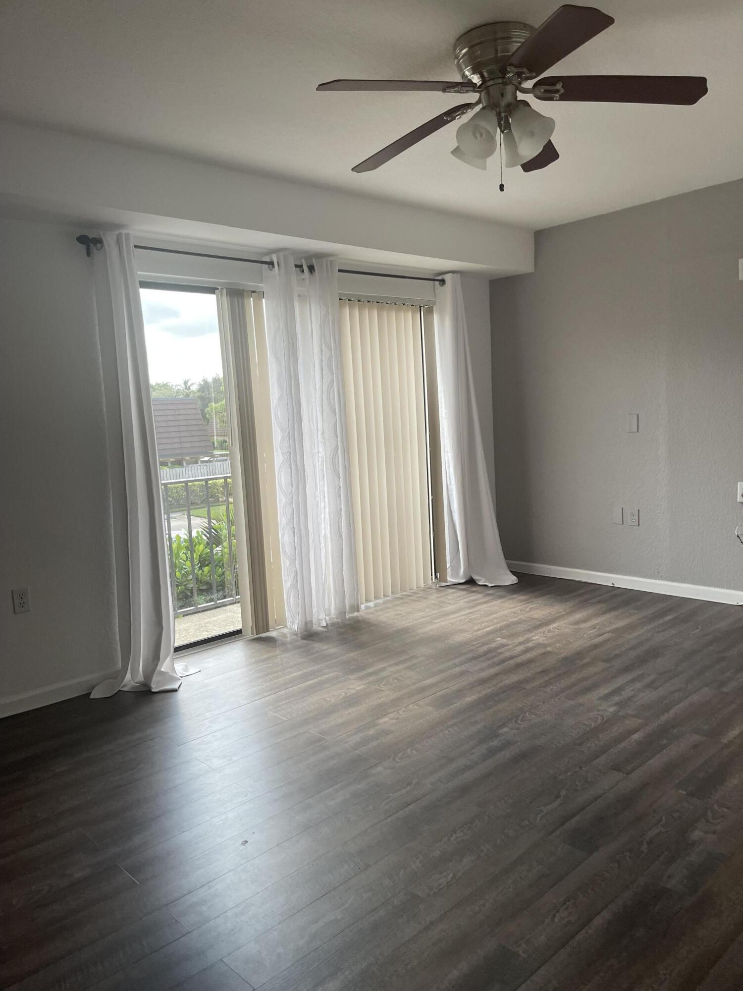 613 6th Lane Palm Beach Gardens, FL 33418 - Photo 11 of 12 a view of an empty room with wooden floor and a window
