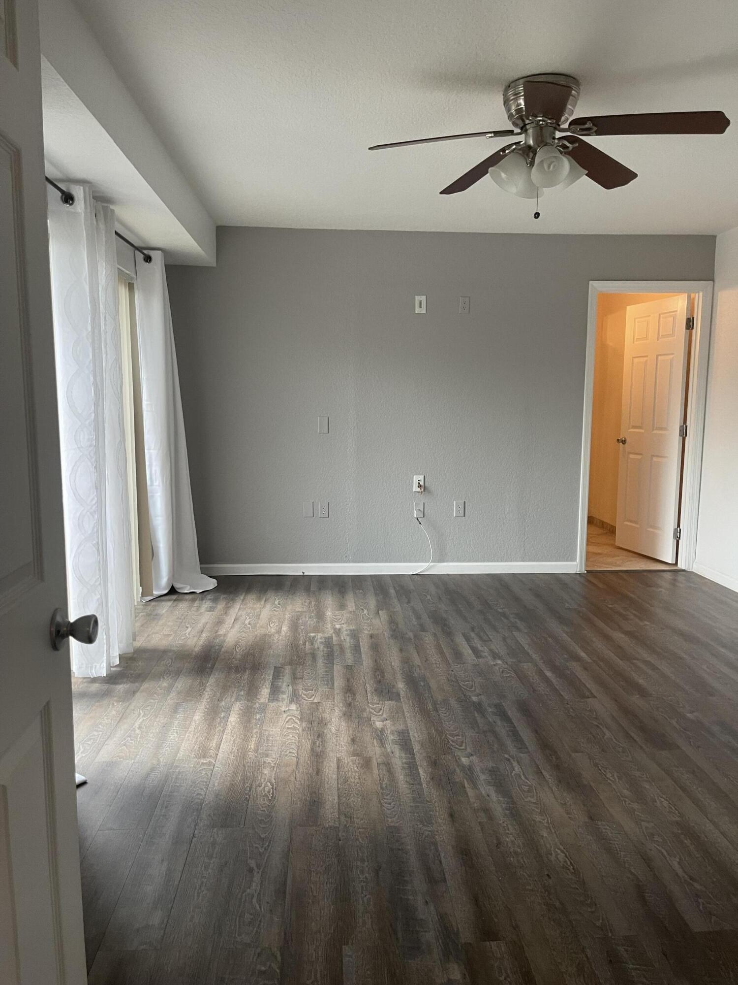613 6th Lane Palm Beach Gardens, FL 33418 - Photo 10 of 12 wooden floor in an empty room with a window