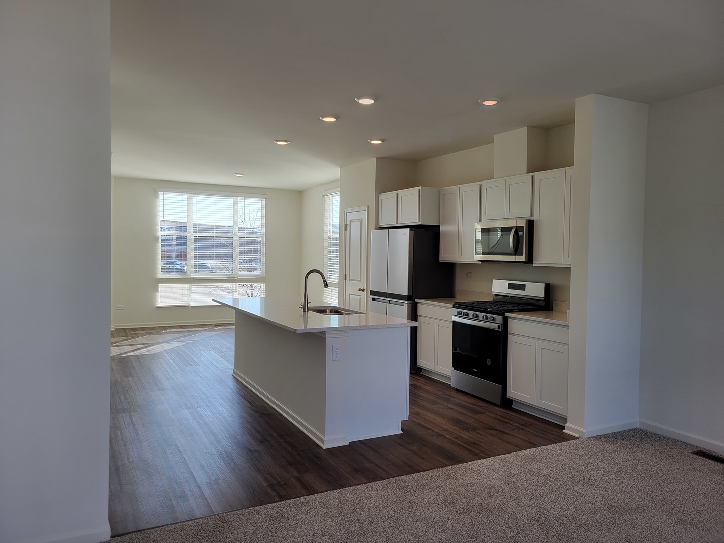 340 Summit Circle Lombard, IL 60148 - Photo 5 of 14 a kitchen with kitchen island white cabinets and stainless steel appliances