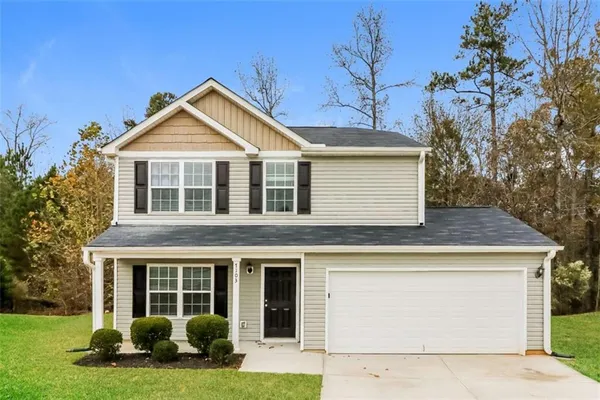 a front view of a house with a yard