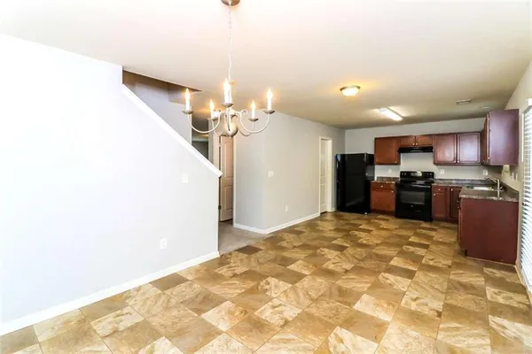 a view of a kitchen with a sink and cabinets