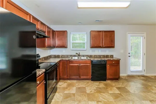 a kitchen with stainless steel appliances granite countertop a stove sink and cabinets