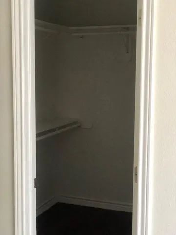 a bathroom with a toilet and a rug