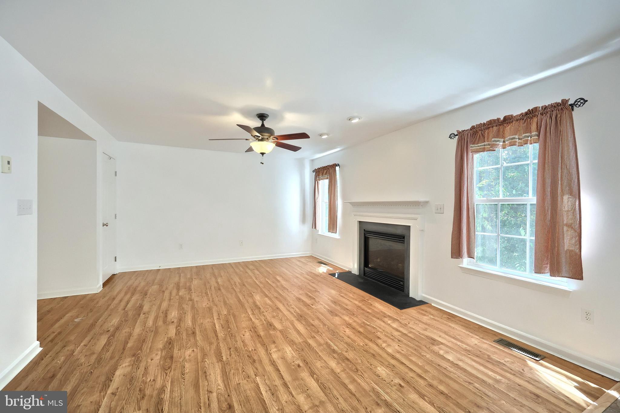425 Lakeview Drive Spring Grove, PA 17362 - Photo 21 of 51 a view of empty room with wooden floor and fireplace
