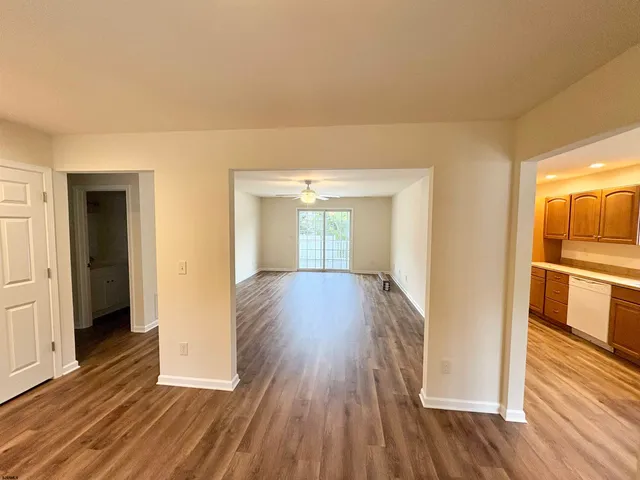 a view of hallway with wooden floor