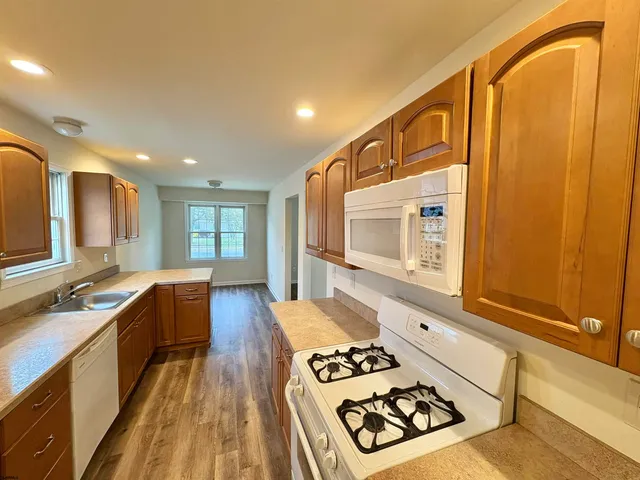 a kitchen with sink refrigerator and stove