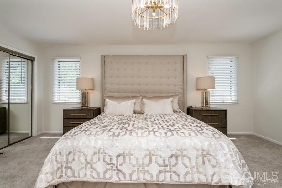 139 Redpine Loop Old Bridge, NJ 08857 - Photo 14 of 24 a bedroom with a bed and a chandelier