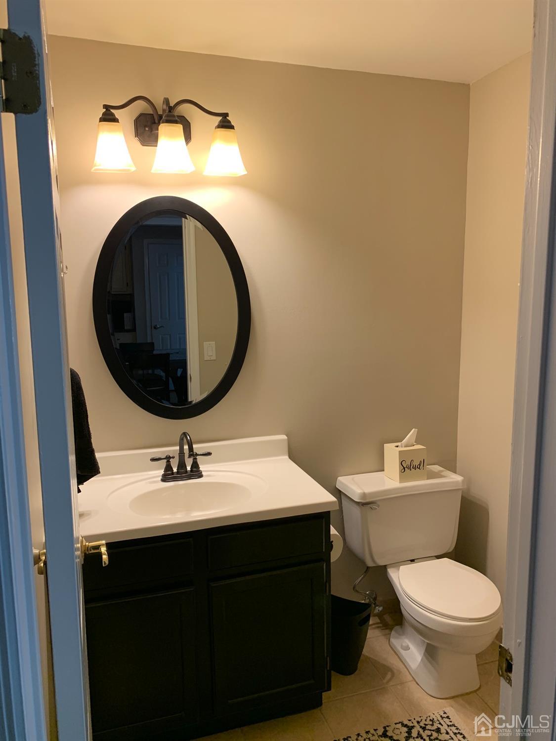 139 Redpine Loop Old Bridge, NJ 08857 - Photo 22 of 24 a bathroom with a sink mirror and toilet