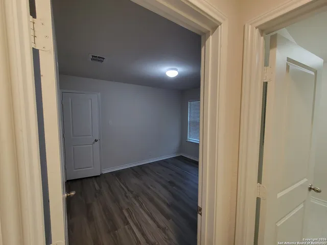 a view of hallway with wooden floor