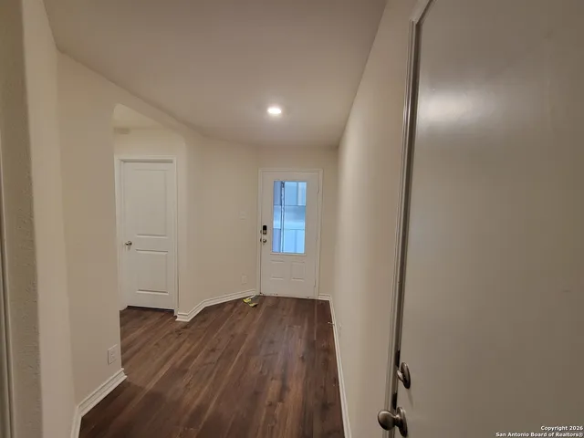 a view of hallway with wooden floor
