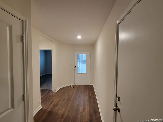 a view of hallway with wooden floor