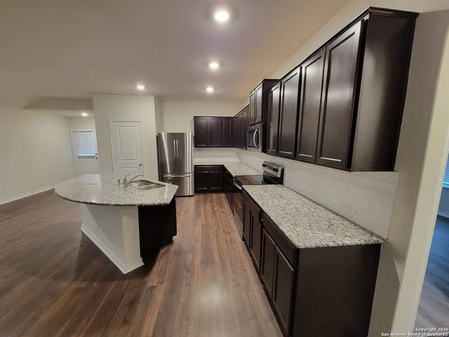a kitchen with a sink and refrigerator