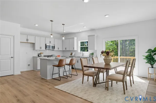a living room with furniture a chandelier fan and a window