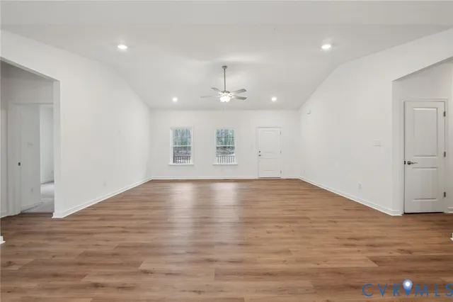 a kitchen with granite countertop white cabinets sink and stainless steel appliances