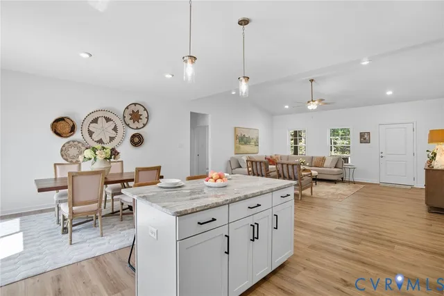 a view of kitchen with granite countertop stainless steel appliances refrigerator oven stove microwave and cabinets