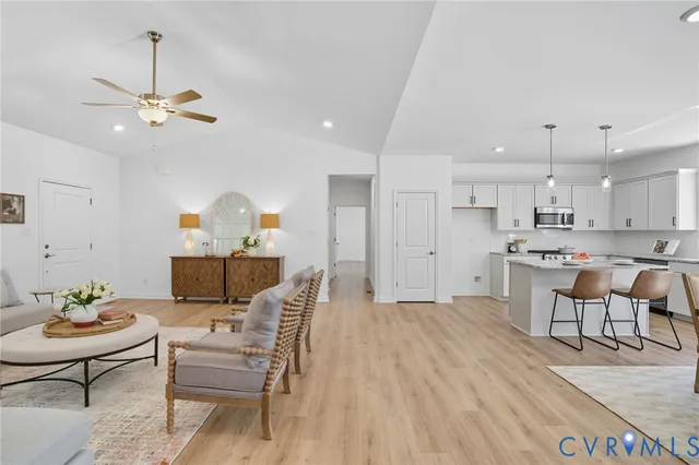 a spacious bedroom with a large bed couch and a window