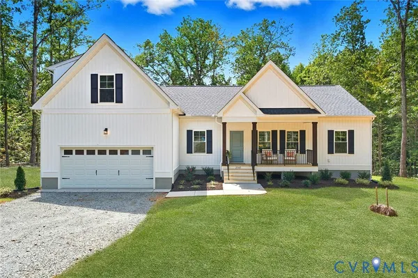 a view of a house with a yard and sitting area