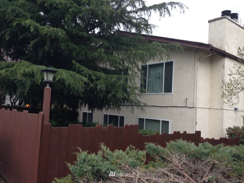 a house that has a tree in front of it