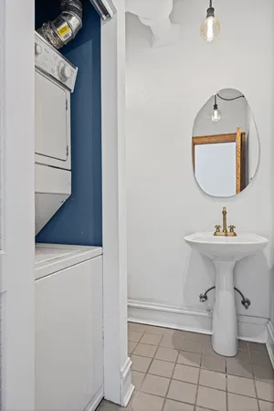 a bathroom with a sink toilet and mirror