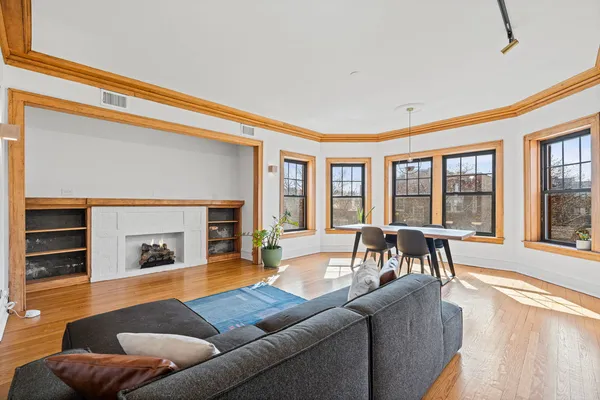 a living room with furniture and a fireplace