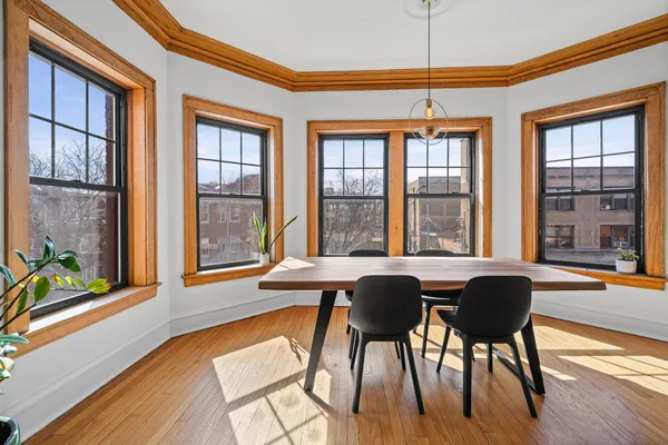 a dining room with furniture and wooden floor