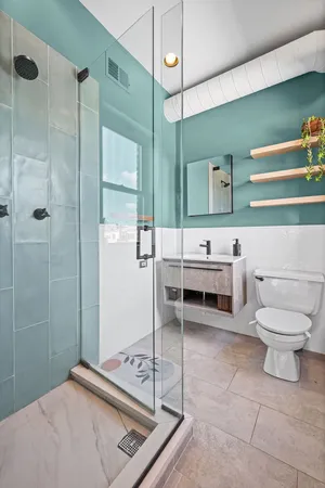 a bathroom with a sink a toilet and a shower