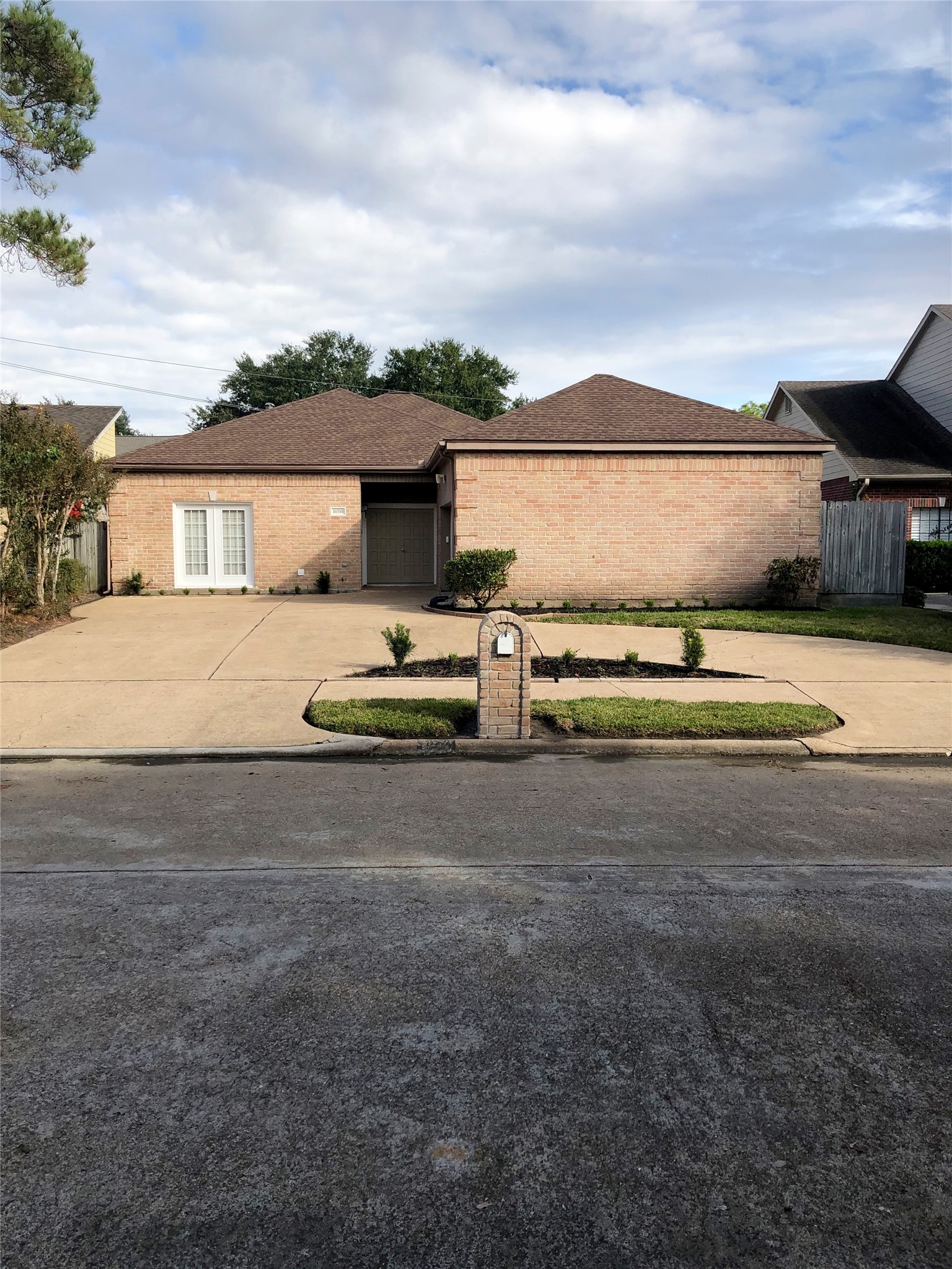 a big house with a big yard and large trees