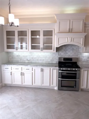 a kitchen with granite countertop a stove and a sink