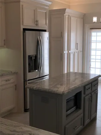 a kitchen with stainless steel appliances granite countertop a refrigerator and a stove