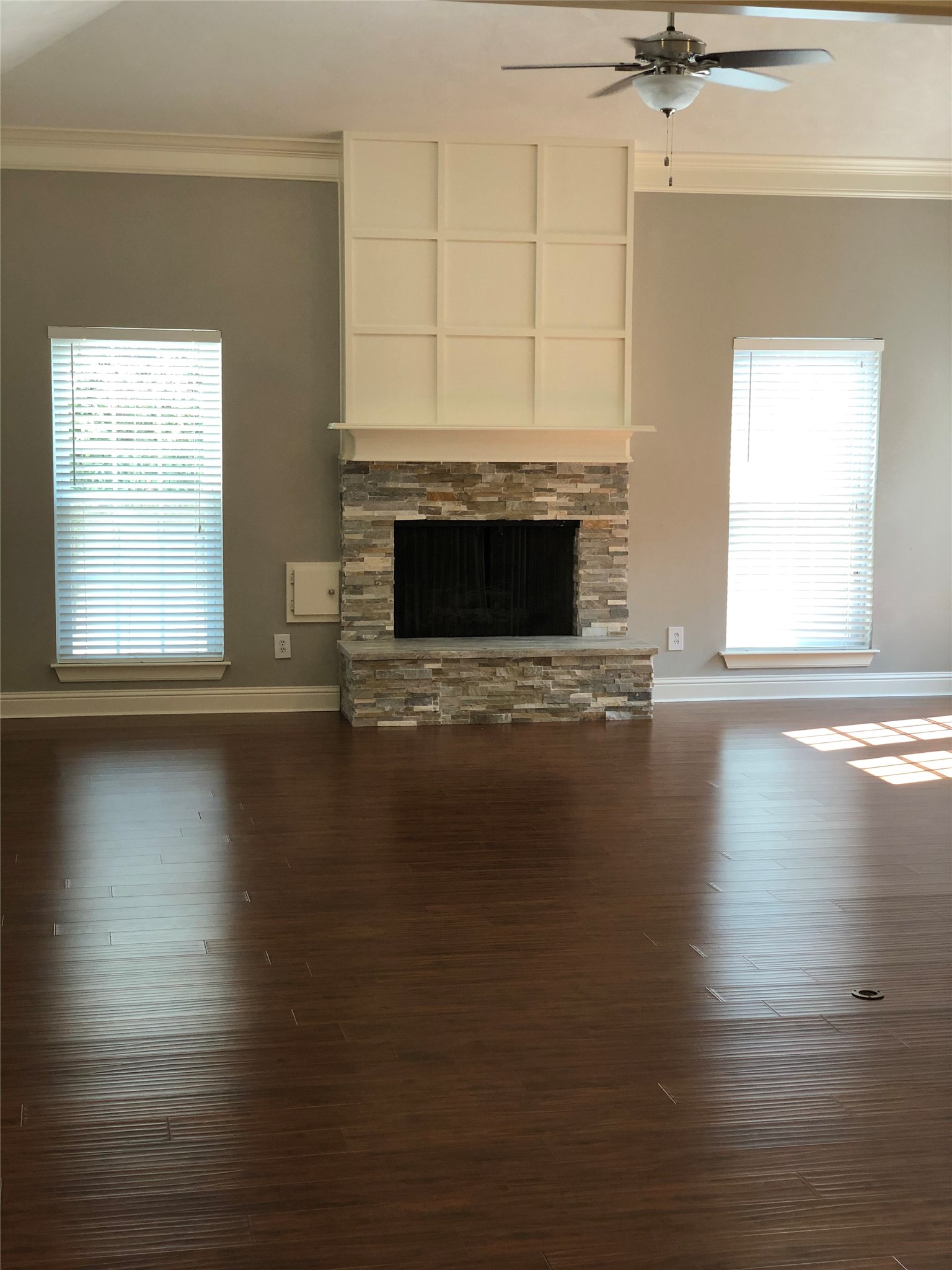 10310 Chevy Chase Drive Houston, TX 77042 - Photo 18 of 36 an empty room with wooden floor fireplace and windows