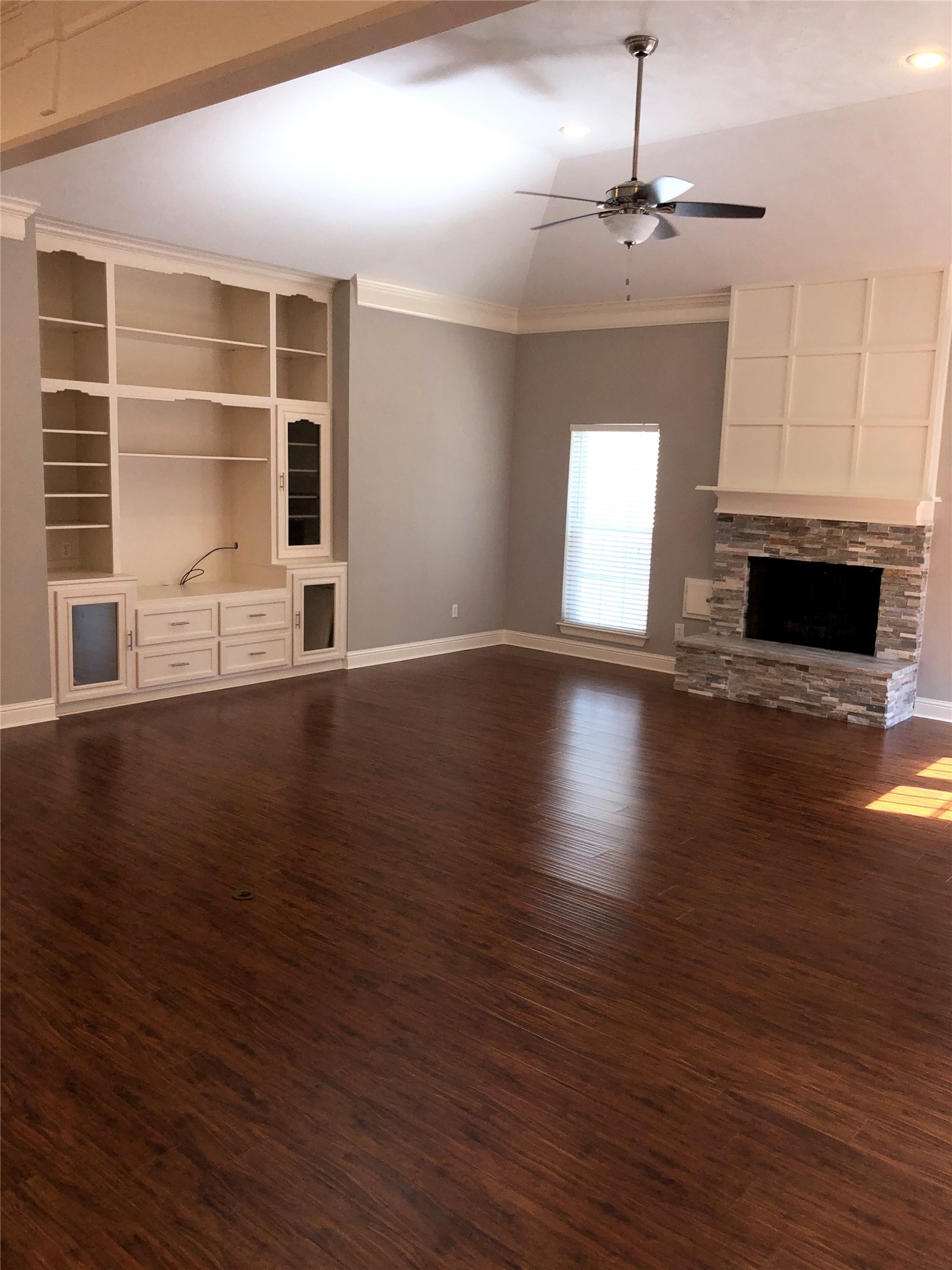 10310 Chevy Chase Drive Houston, TX 77042 - Photo 20 of 36 an empty room with wooden floor fireplace and windows