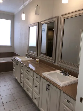 a bathroom with a double vanity sink and a mirror