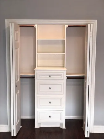 a view of walk in closet with empty racks