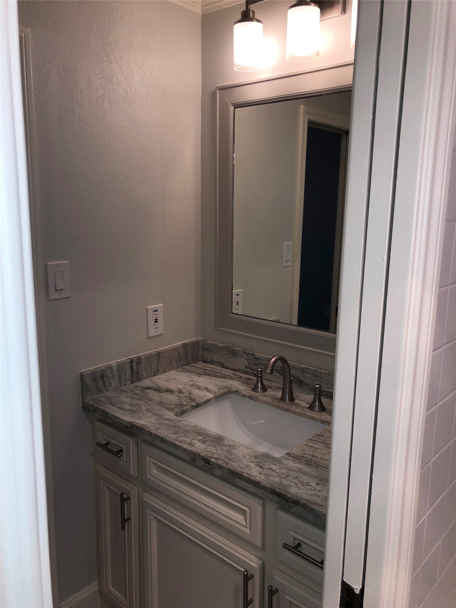 10310 Chevy Chase Drive Houston, TX 77042 - Photo 27 of 36 a bathroom with a sink and a mirror