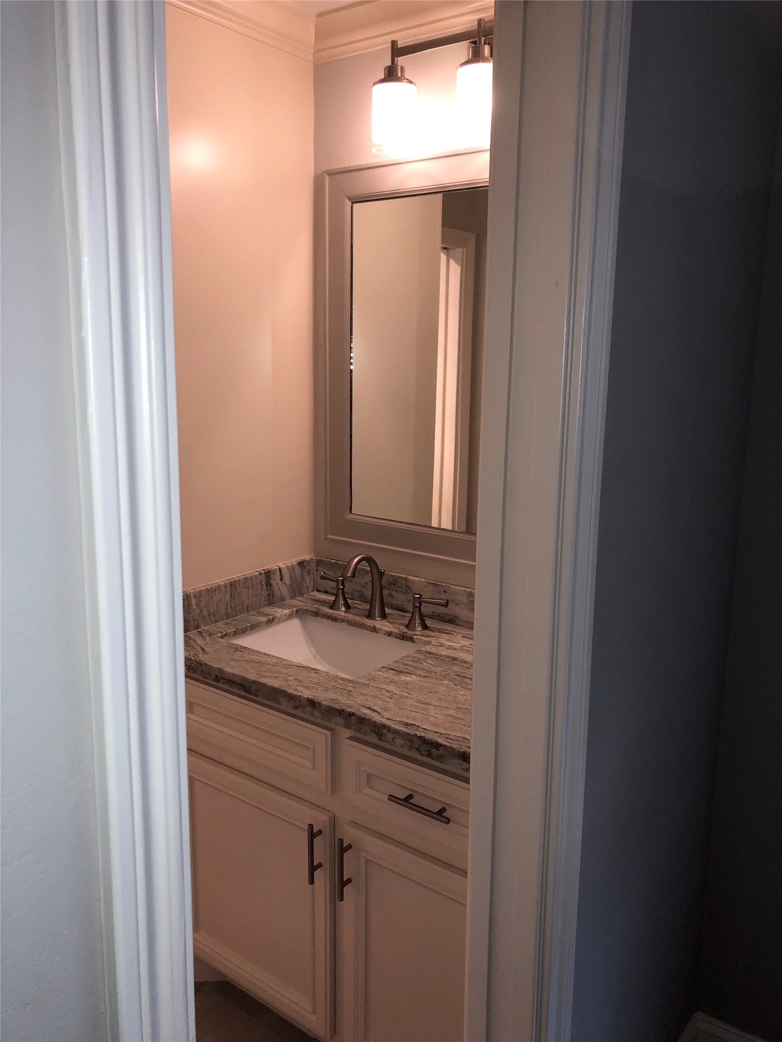 10310 Chevy Chase Drive Houston, TX 77042 - Photo 28 of 36 a bathroom with a sink and a mirror