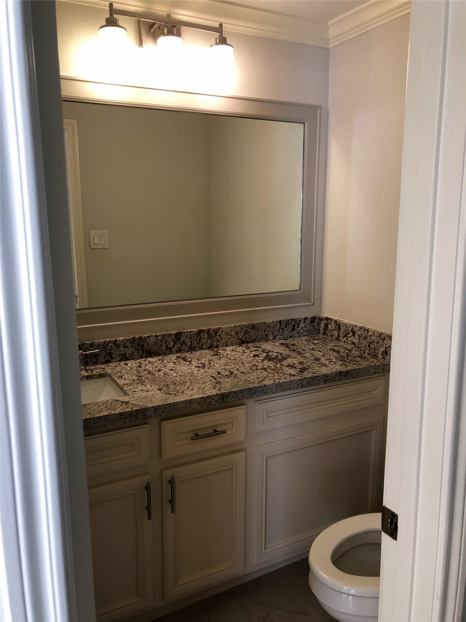 10310 Chevy Chase Drive Houston, TX 77042 - Photo 31 of 36 a bathroom with a granite countertop toilet and a sink