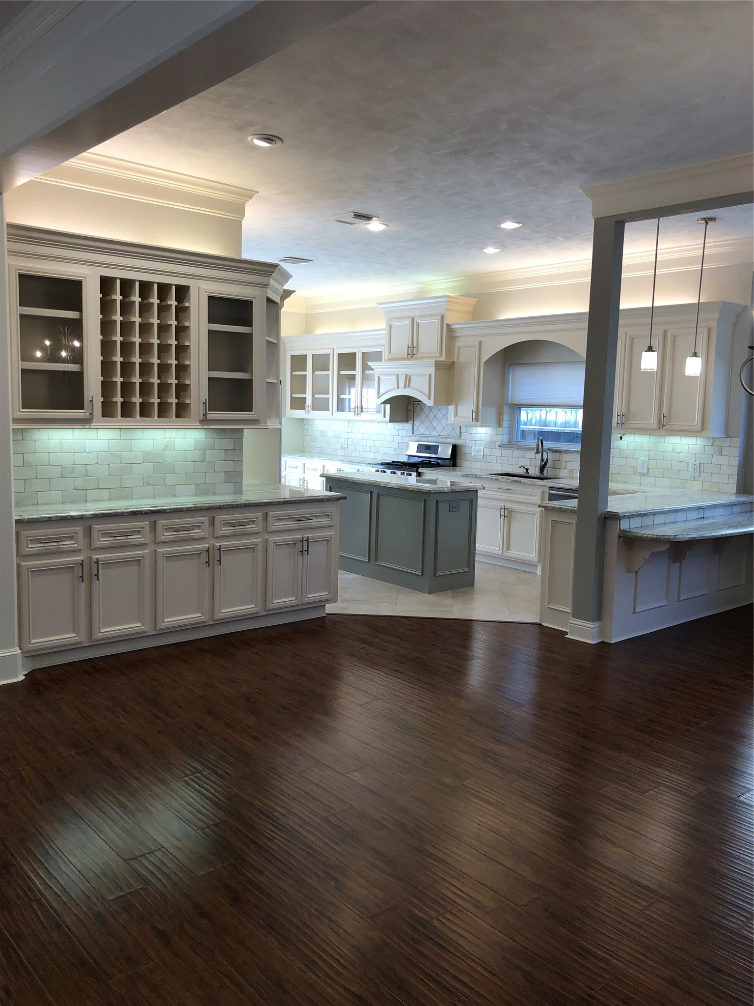 10310 Chevy Chase Drive Houston, TX 77042 - Photo 6 of 36 a kitchen with stainless steel appliances granite countertop a sink cabinets and wooden floor