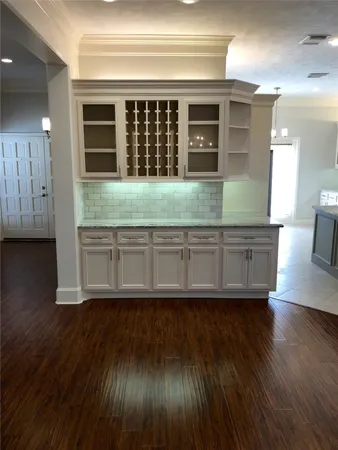 a view of kitchen with granite countertop cabinets and wooden floor
