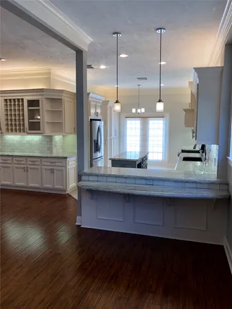 a open kitchen view with a wooden floor and large windows
